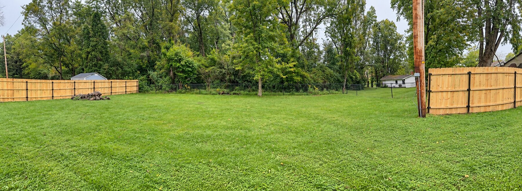 Wide view of partial privacy fencing combined with chain-link fencing